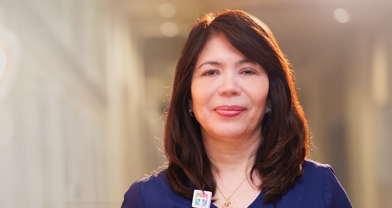A smiling woman with long, brown hair