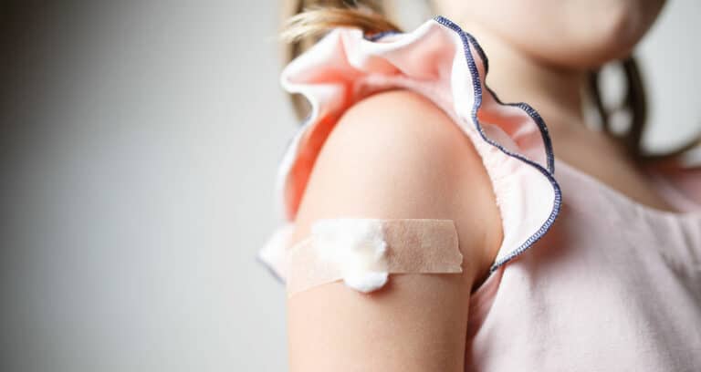 child with bandaid on arm