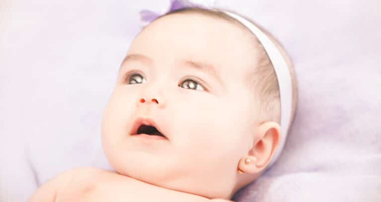 infant with pierced ears