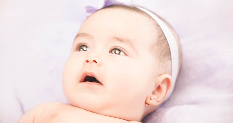infant with pierced ears