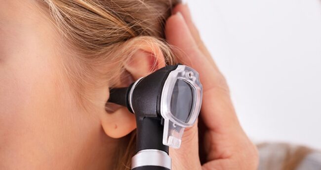 ChildrensHealth_2022-0222_KnowYourENTs medical professional examining child's ear