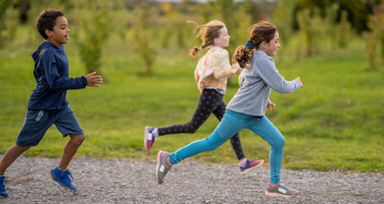 kids running on a gravel road