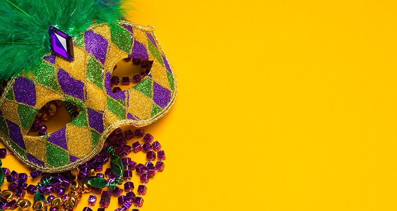 mardi gras mask on yellow background
