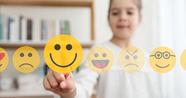 ChildrensHealth_20220307_TipsSupportMentalHealth girl touching superimposed emojis