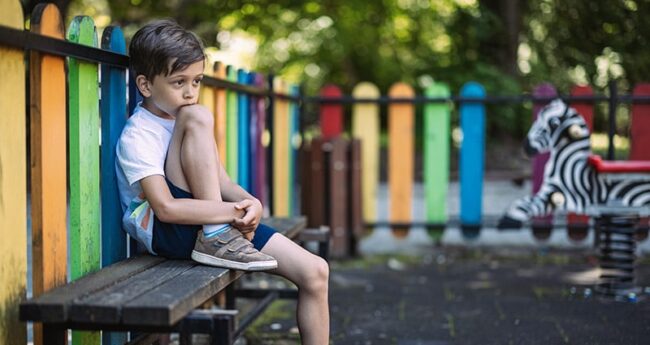 ChildrensHealth_20220325_UnderstandingAutism child sitting on a playground