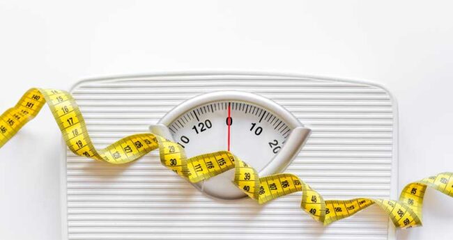 weight_loss stock art image of a scale and measuring tape