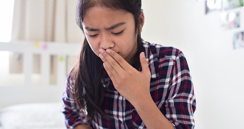 tween holding her mouth and stomach as if nauseous