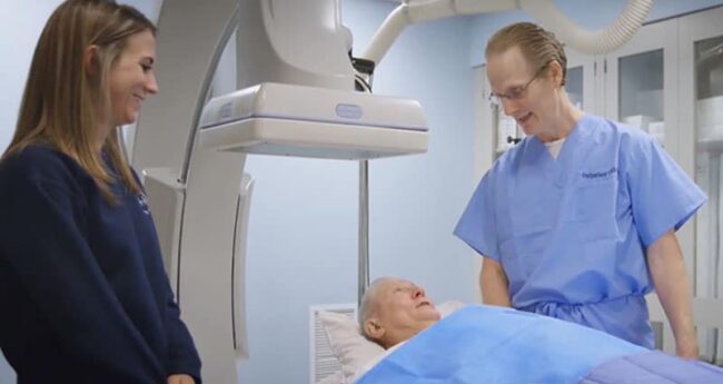 WLWH_LakeBrandedContent3_web Medical professional speaking with patient lying in bed