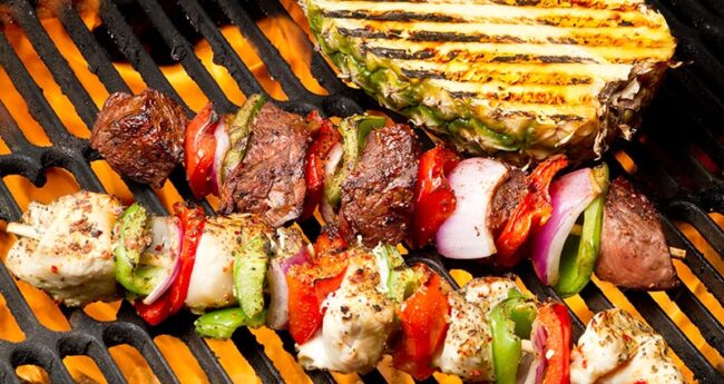 skewered meat and vegetables on grill