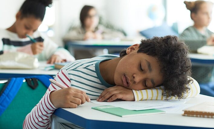 boy sleeping in class