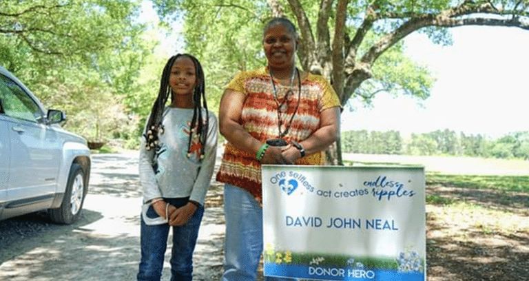adult and child standing side by side outdoors