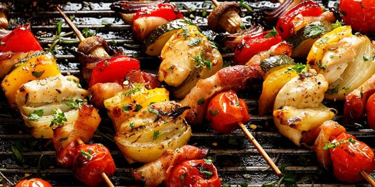 EatingWell_20220902_HealthyTailgateRecipes skewered veggies and chicken on grill