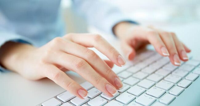 hands typing on keyboard