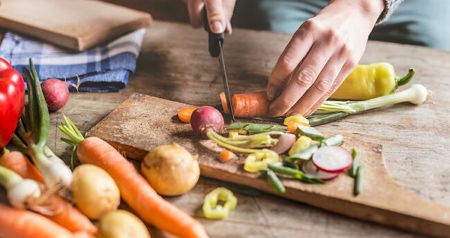 person chopping vegetables