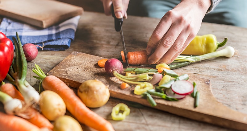 person chopping vegetables