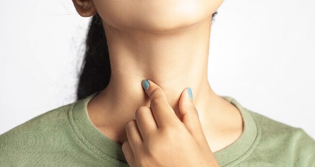 Woman holding her neck woman holding throat