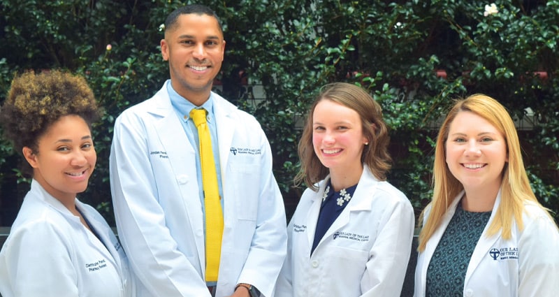 group of medical professionals smiling outdoors