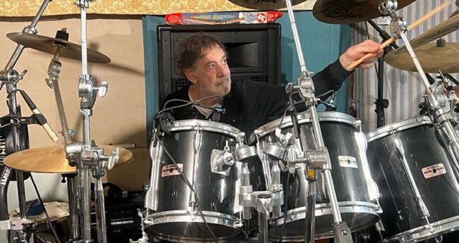 man playing on a drum set