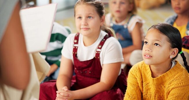 child listening to teacher in class