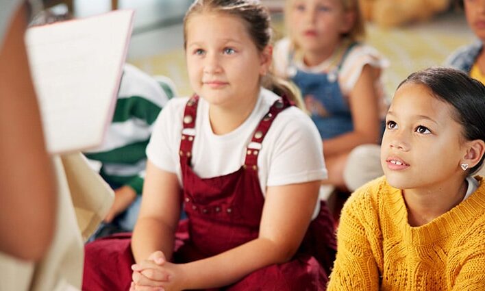 child listening to teacher in class