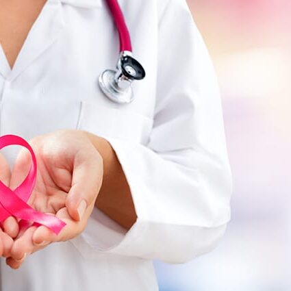 doctor holding pink ribbon