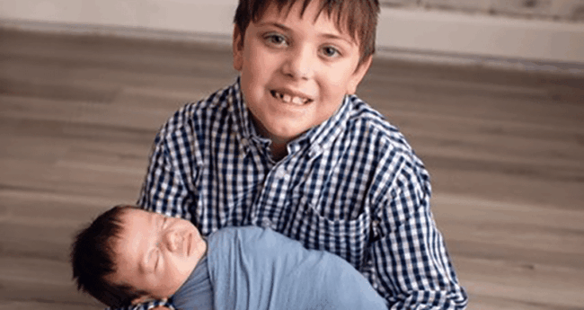 AcadianaNICUFamily_BlogFeature young boy holding infant and smiling