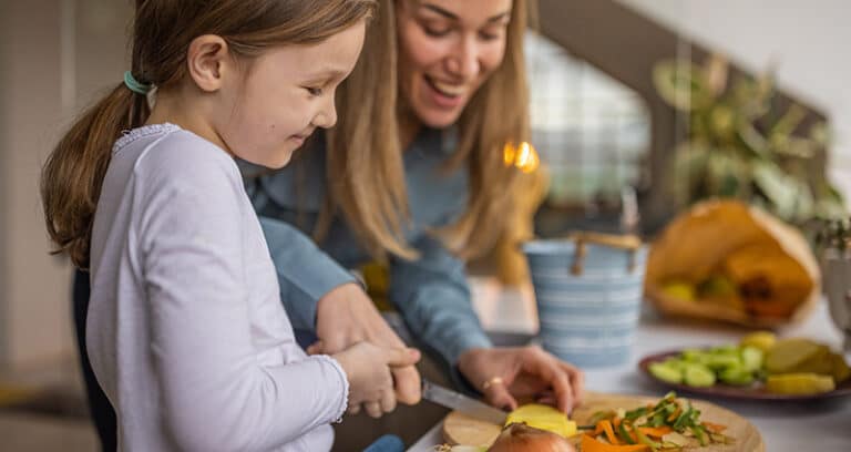 mom and daughter working in kitchen