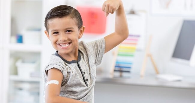 ChildrensHealth_20240428_ParentsPrimerOnVaccines tween showing off bandaid from vaccine