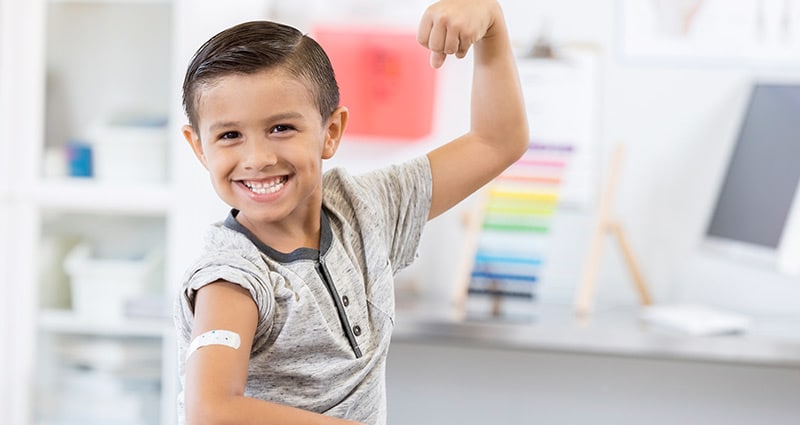 tween showing off bandaid from vaccine