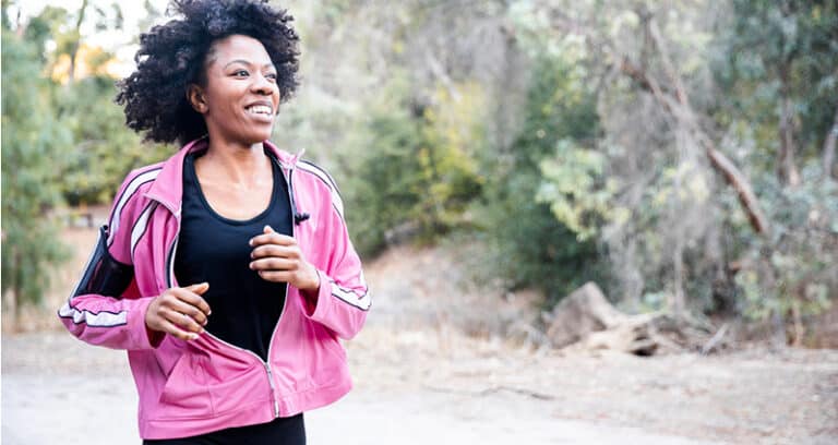 smiling woman running on trails