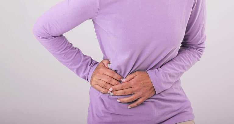 woman clutching her waist