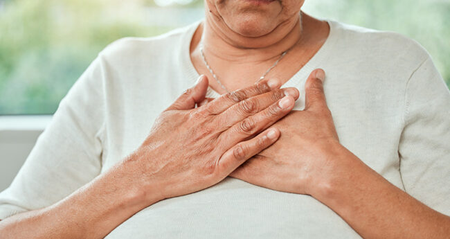 woman holding hands to chest