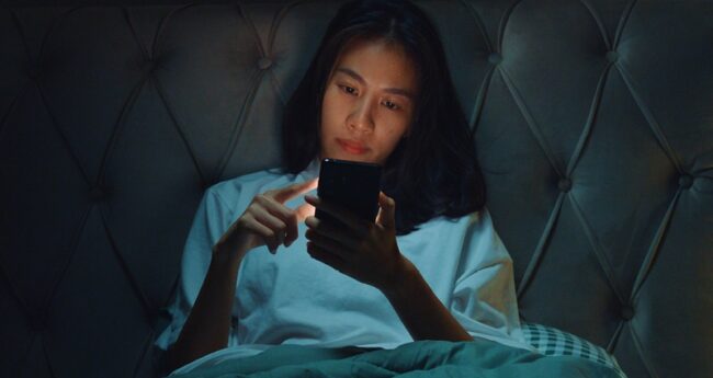 woman scrolling on her phone