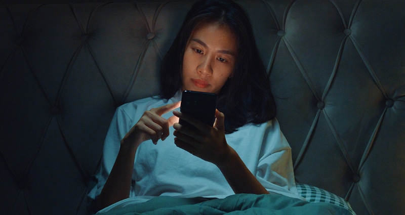 woman scrolling on her phone