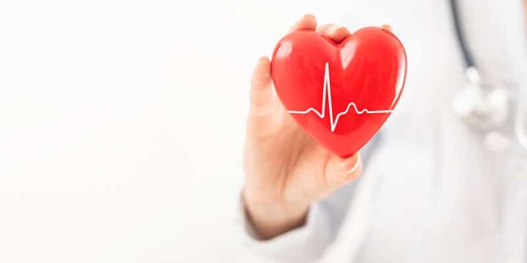 provider holding red heart-shape