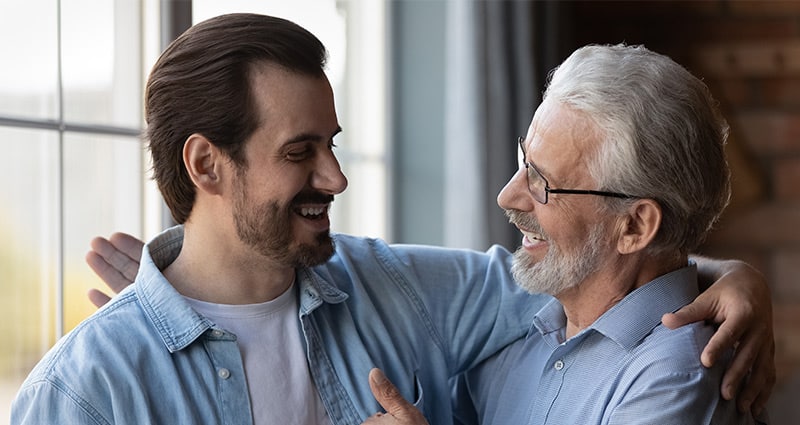 man and dad embracing