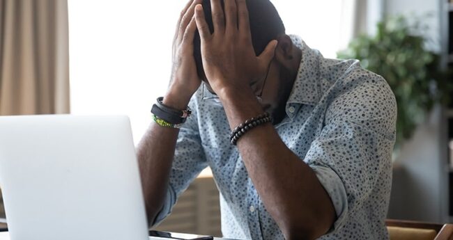 HeartHealth_20220218_MenInHighStressJobs man holding head in his hands