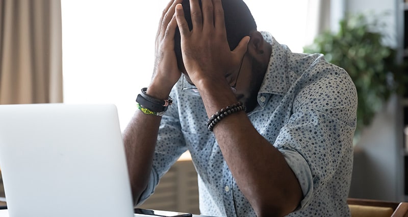 man holding head in his hands