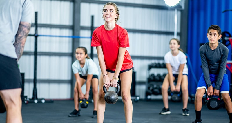 teens using kettlebell weights