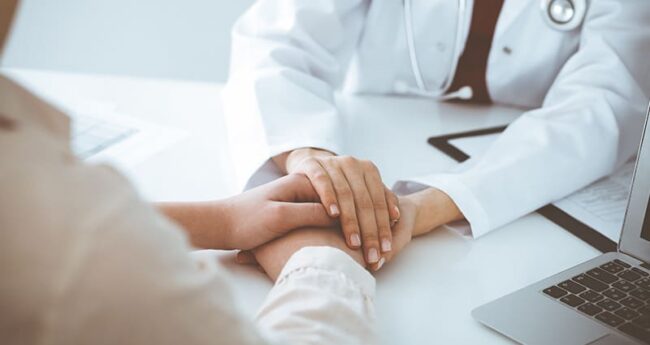 provider and patient holding hands