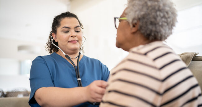 Provider listening to a patient’s heart with stethoscope