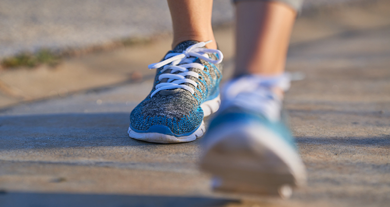 A closeup of a person's shoes while walking