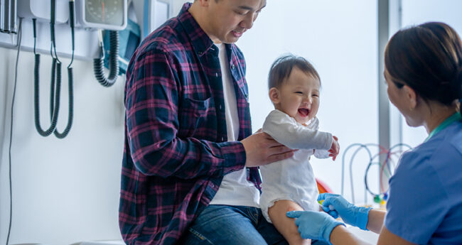 Happy baby getting vaccine
