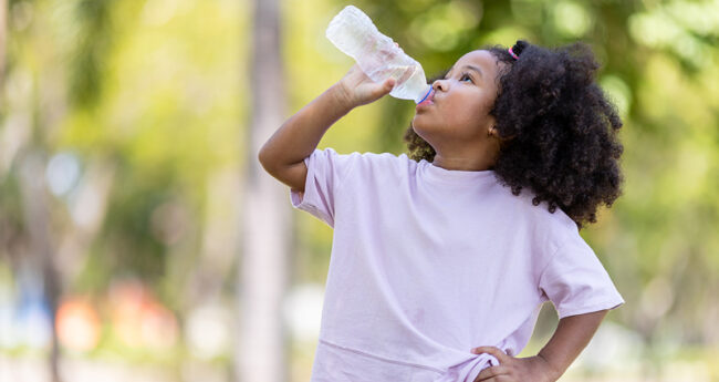 Girl Drinking Water on a Hot Day