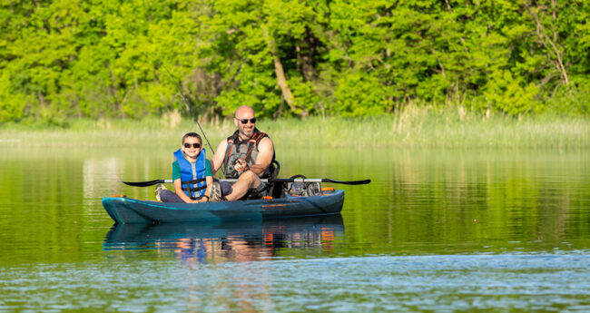 Father and Son in Kayak wearing lifejackets