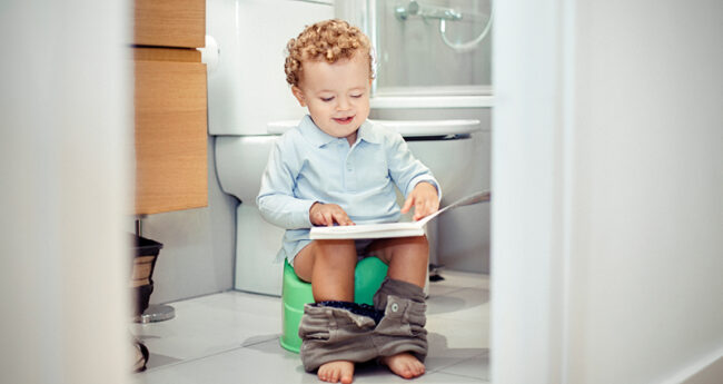 Toddler on a Potty reading a book